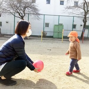 ボールで遊ぶ子どもと保育士