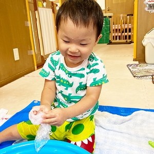 ビニール袋と水で遊ぶ子ども