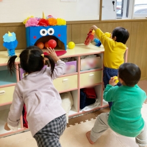 鬼の口にボールを入れて鬼退治をする子ども