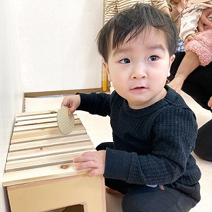賽銭箱にお賽銭を入れる子ども