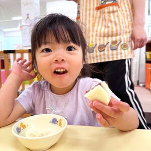 手作りおやつを頬張る子ども